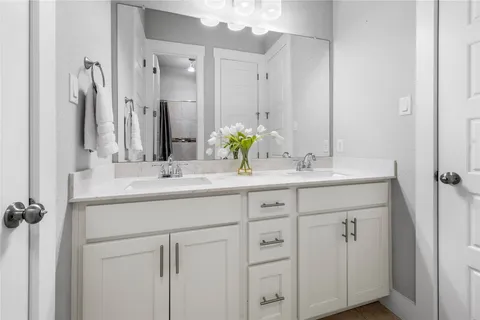 a bedroom with a bed and a potted plant