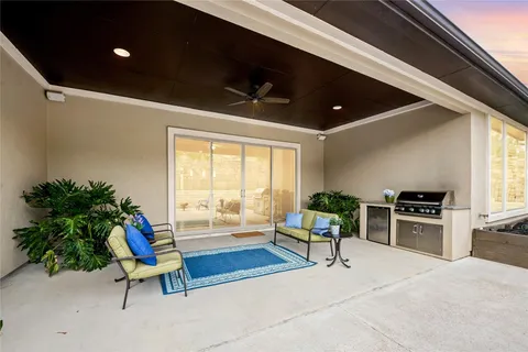 a living room with furniture a potted plant and a flat screen tv