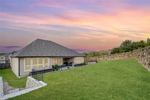 a view of a house with a yard and a garden