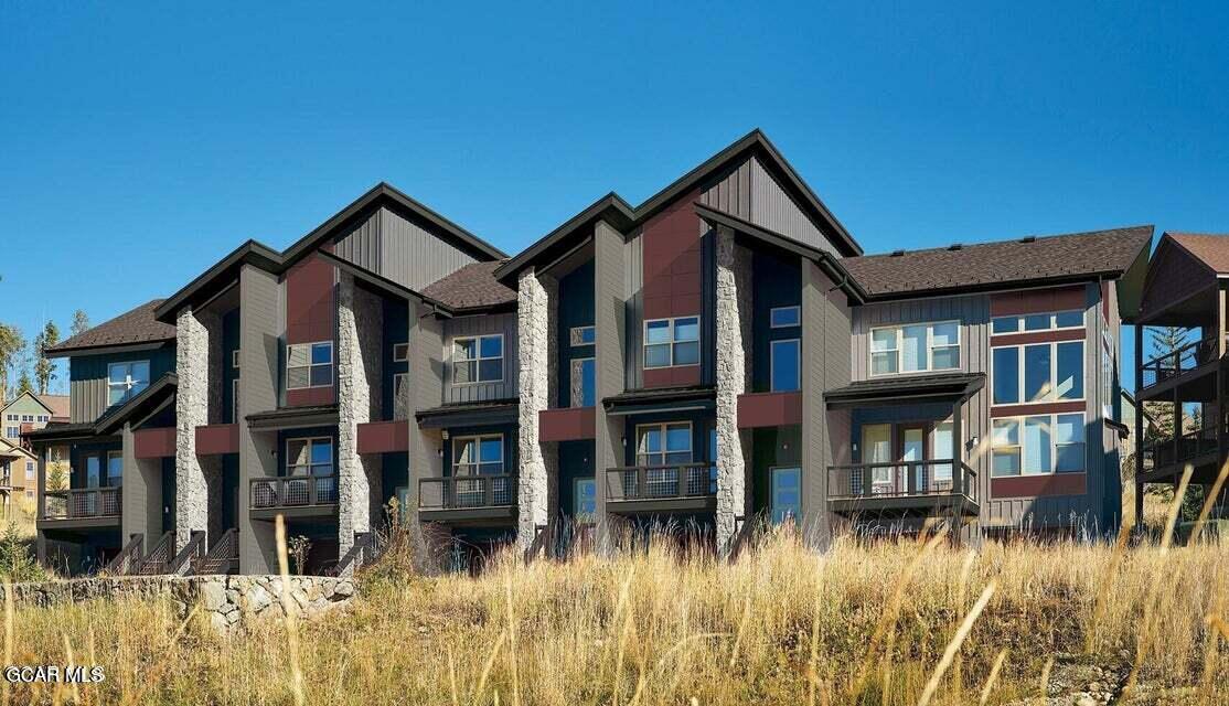 a front view of brick house with a yard