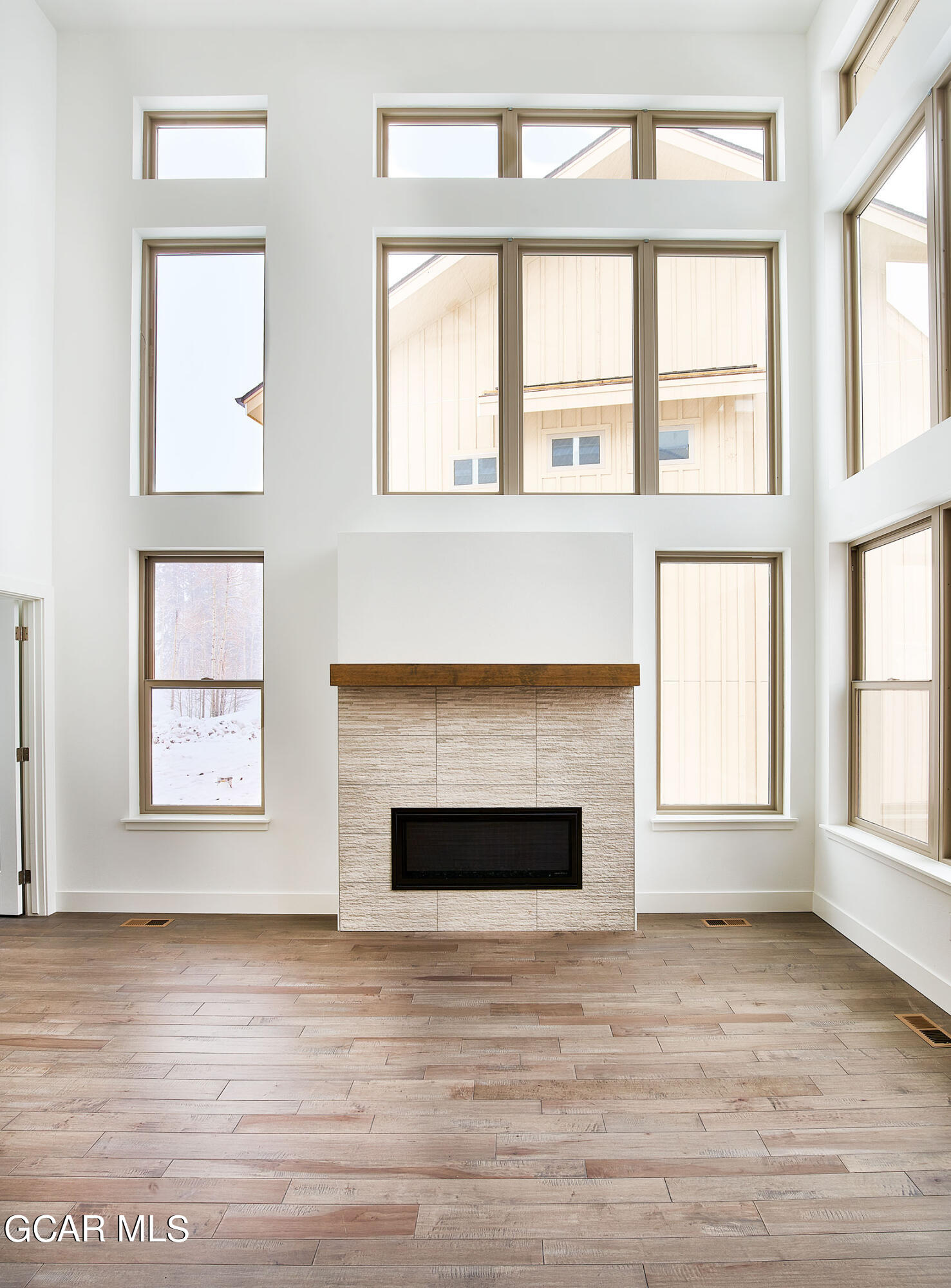 156 Homestead Loop Fraser, CO 80442 - Photo 7 of 16 a view of empty room with wooden floor and fireplace