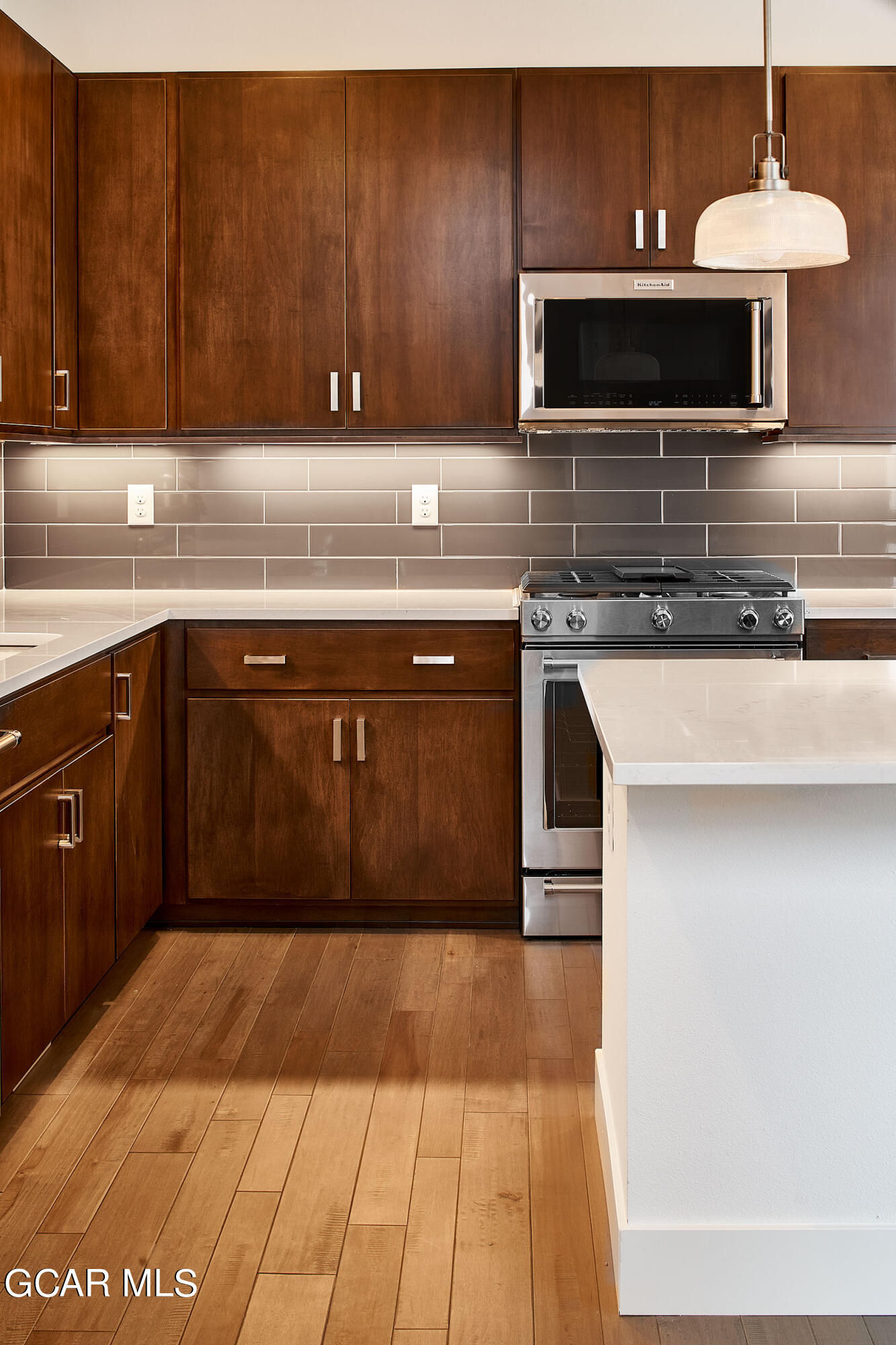 156 Homestead Loop Fraser, CO 80442 - Photo 9 of 16 a kitchen with stainless steel appliances granite countertop a stove a sink and a microwave