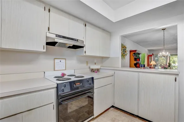 a kitchen with stainless steel appliances a stove a sink and cabinets