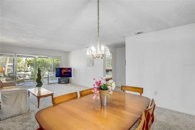 a dining room with furniture and a chandelier