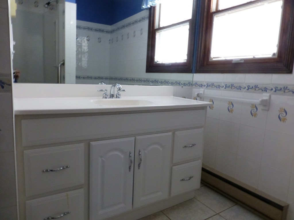 57 Florence Road Easthampton, MA 01027 - Photo 18 of 29 a bathroom with a granite countertop sink and a mirror