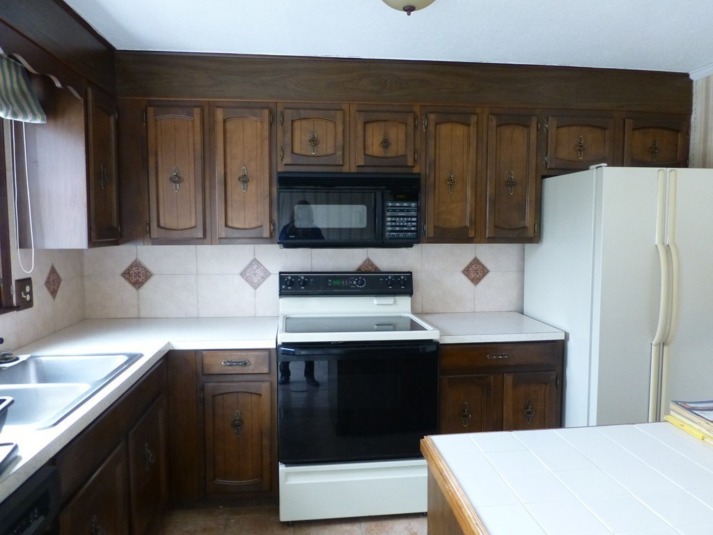 57 Florence Road Easthampton, MA 01027 - Photo 8 of 29 a kitchen with stainless steel appliances a sink a stove a refrigerator a cabinets and wooden floor