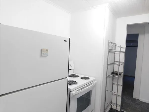 a kitchen with a stove and a refrigerator