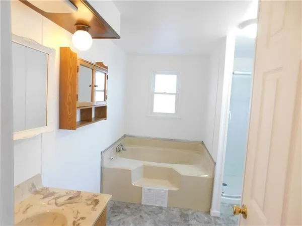 a bathroom with a tub and a window