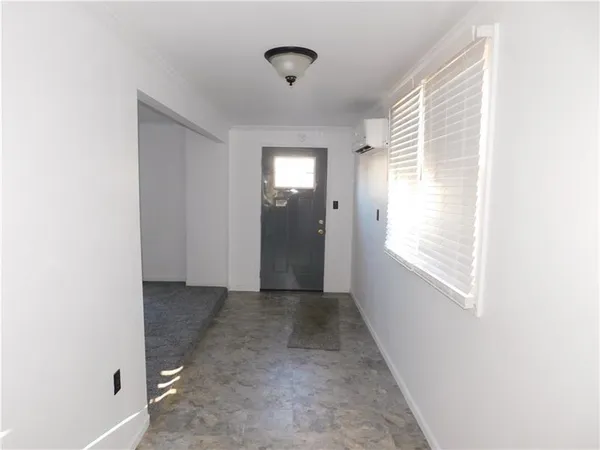 a view of hallway with window and stairs