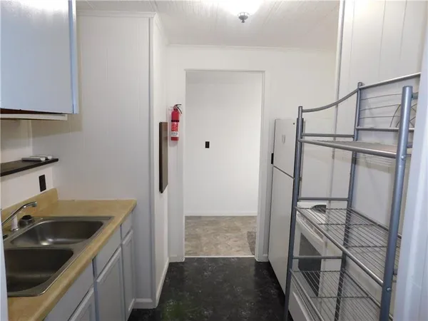 a kitchen with a sink and refrigerator