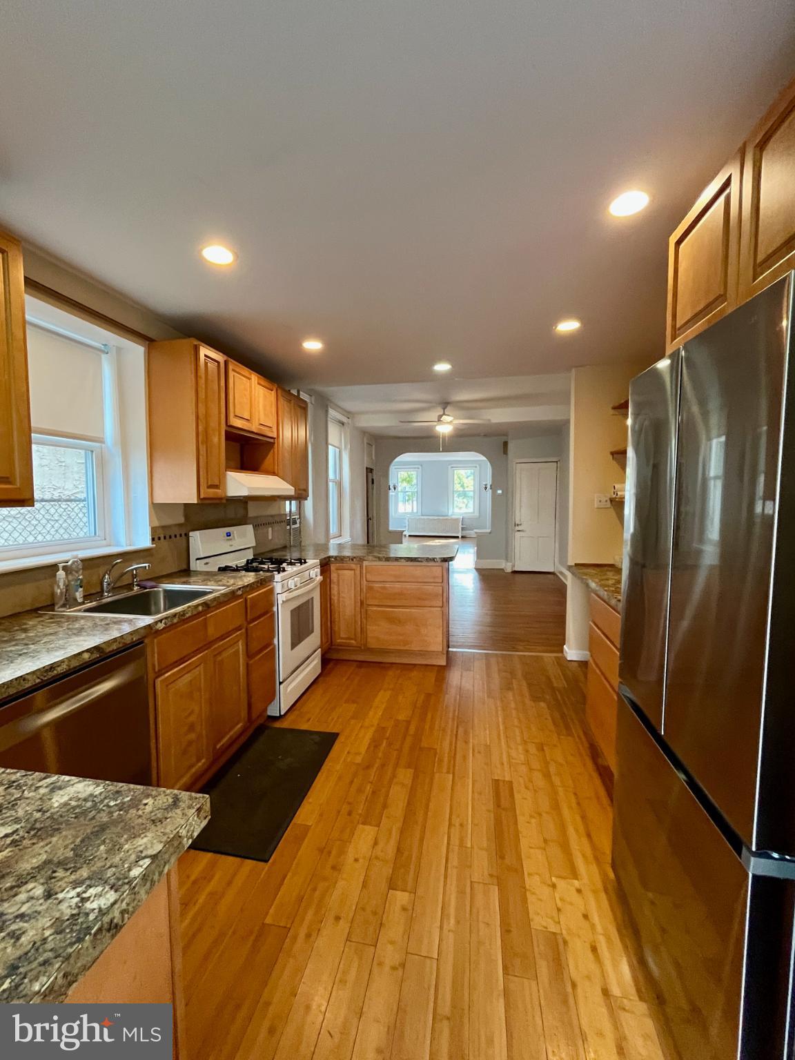 1217 Wharton Street Philadelphia, PA 19147 - Photo 12 of 27 a large kitchen with a center island wooden floor stainless steel appliances and cabinets