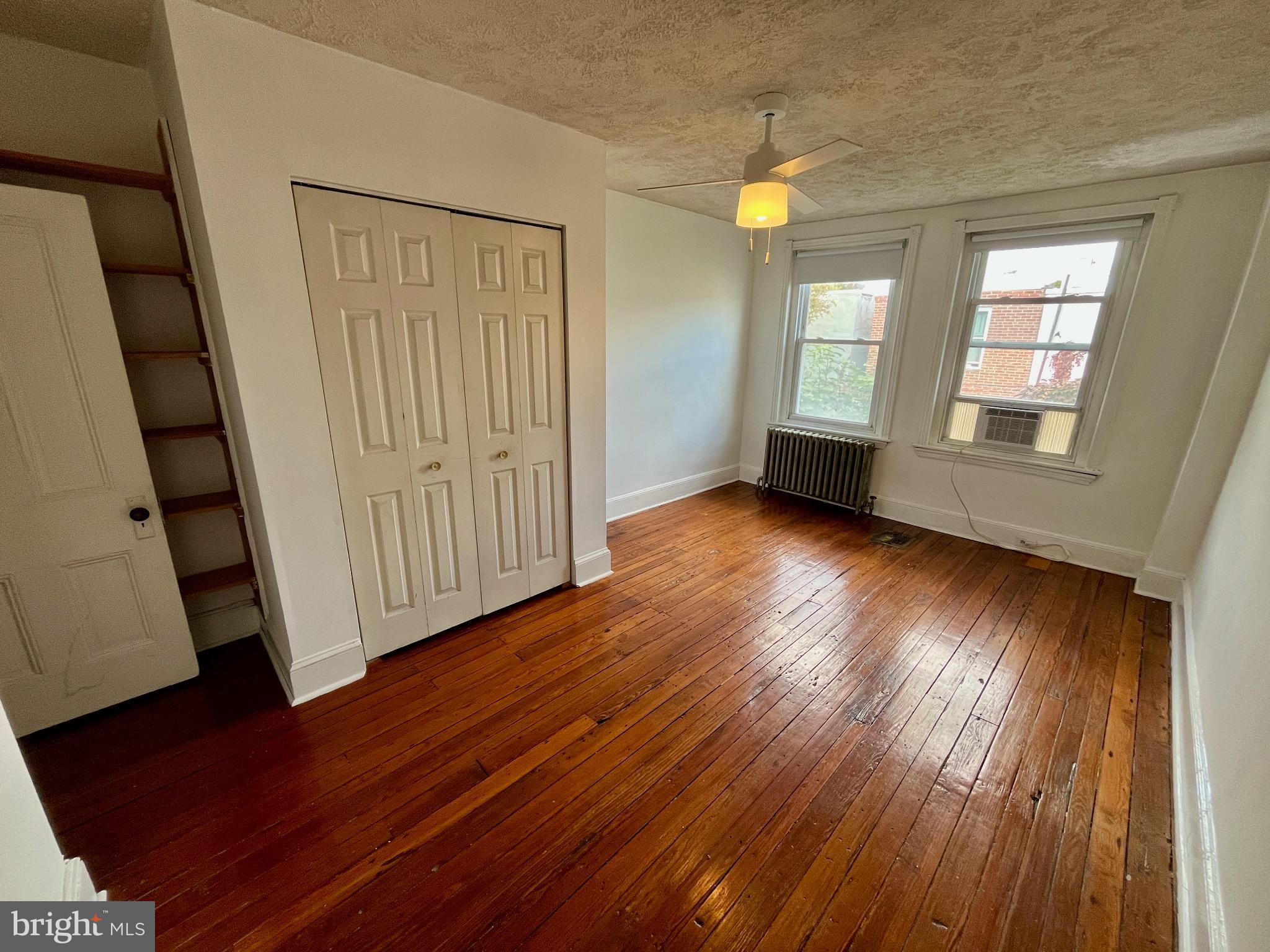 1217 Wharton Street Philadelphia, PA 19147 - Photo 19 of 27 a view of an empty room with wooden floor and a window