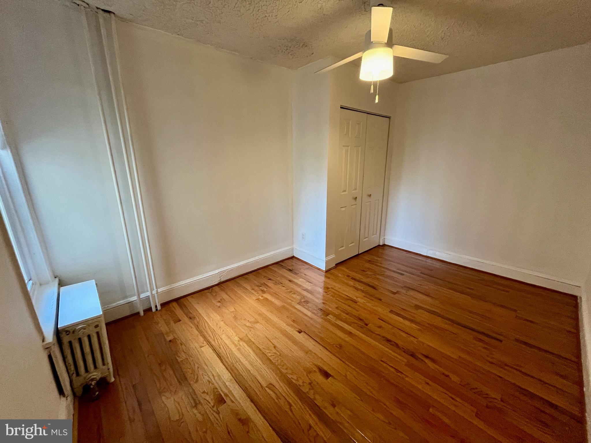 1217 Wharton Street Philadelphia, PA 19147 - Photo 21 of 27 a view of an empty room with wooden floor and a window