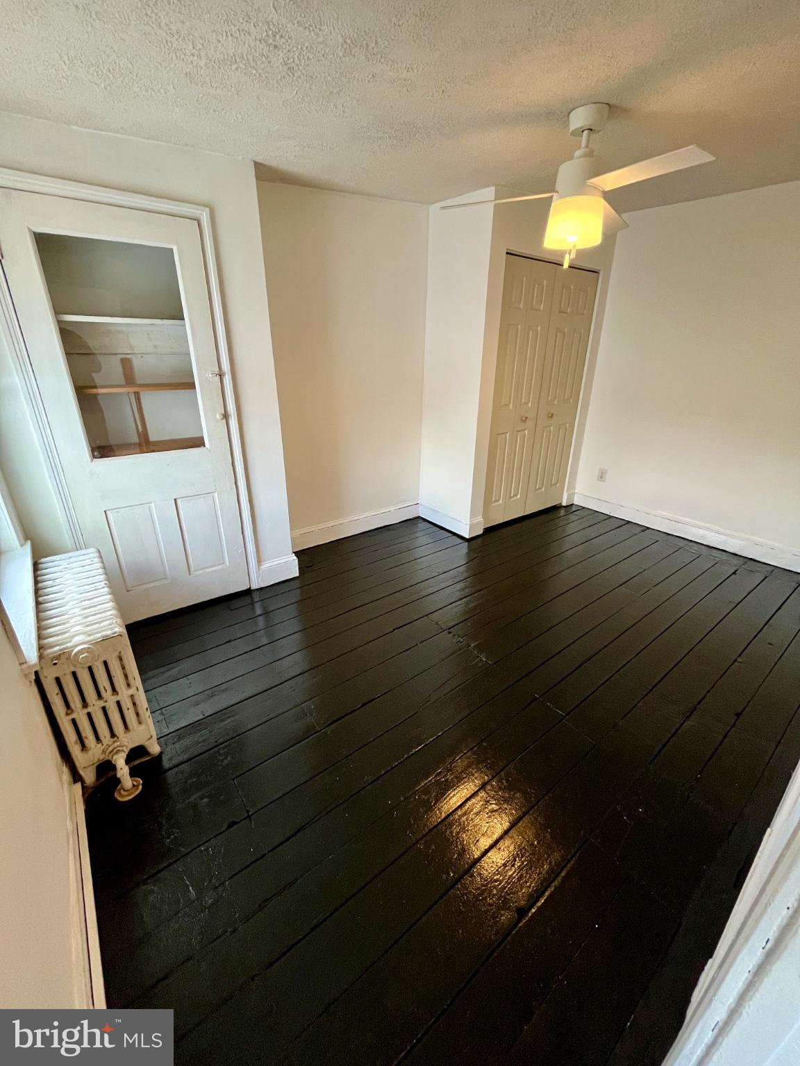 1217 Wharton Street Philadelphia, PA 19147 - Photo 25 of 27 a view of an empty room with wooden floor and a window