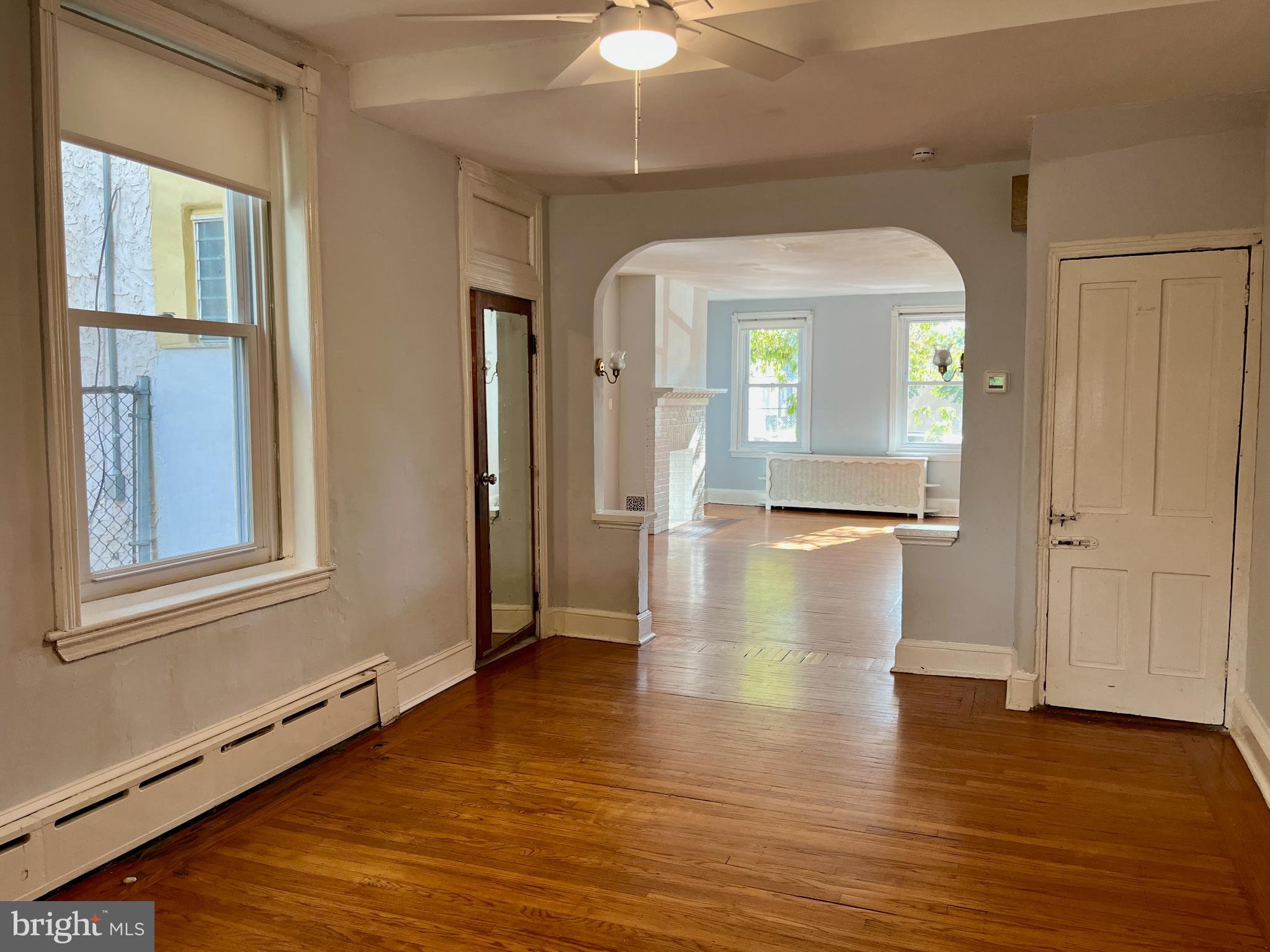 1217 Wharton Street Philadelphia, PA 19147 - Photo 6 of 27 a view of a livingroom with wooden floor and a ceiling fan