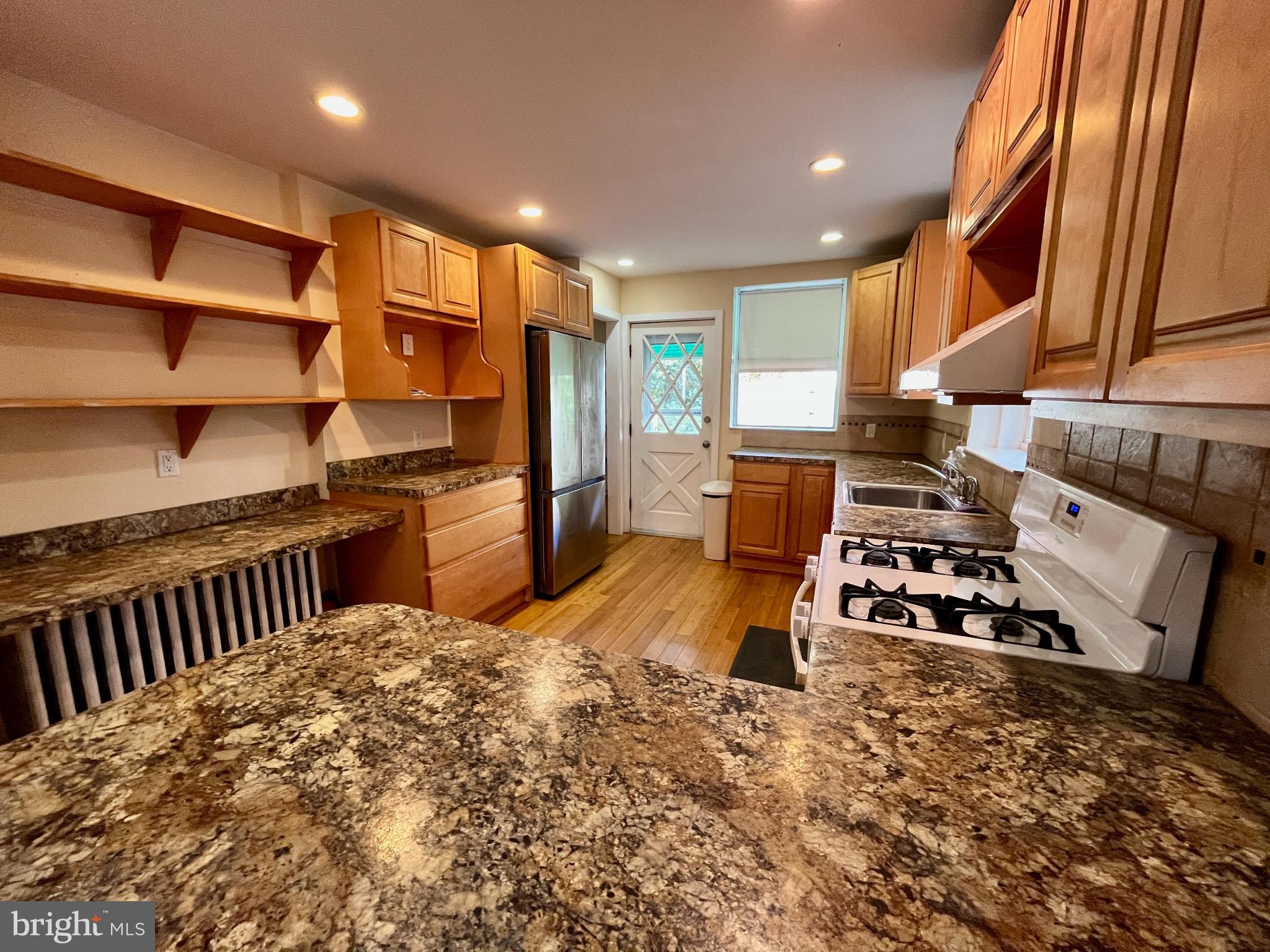 1217 Wharton Street Philadelphia, PA 19147 - Photo 9 of 27 a kitchen with stainless steel appliances granite countertop a stove a sink and a refrigerator