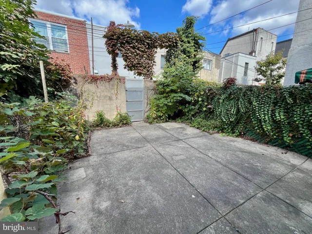a view of backyard of house with green space