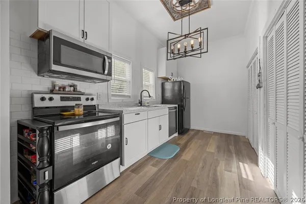a kitchen with sink cabinets and window