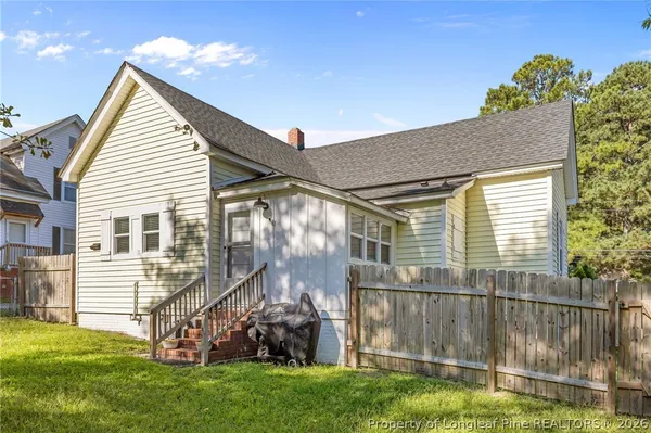 a view of a house with a yard and furniture