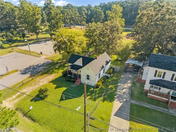 a view of a house with a yard and sitting area