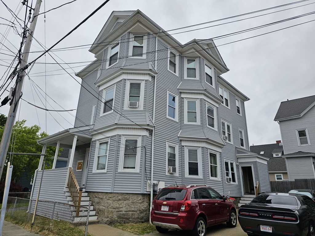a front view of a residential apartment building with a yard