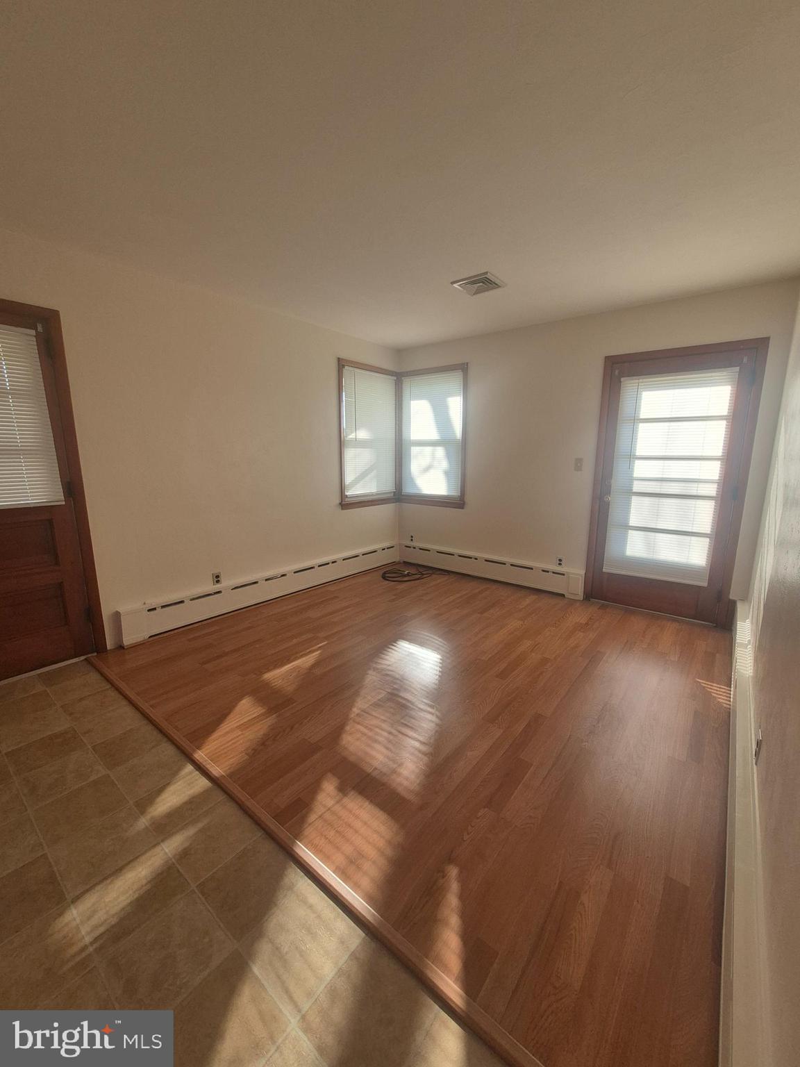 4866 Trento Avenue Vineland, NJ 08361 - Photo 6 of 15 an empty room with wooden floor and windows