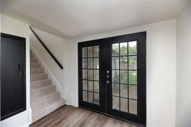 a view of staircase with wooden floor and windows