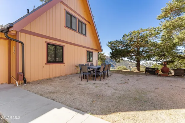 a view of a backyard with sitting area