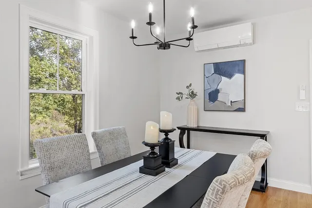 a living room with furniture chandelier and a window