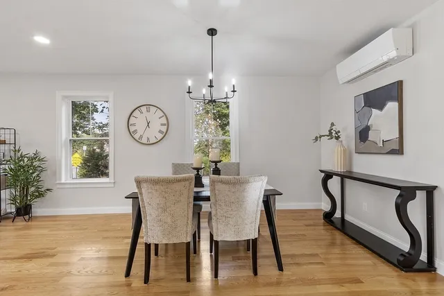 a view of a dining room with furniture window and wooden floor