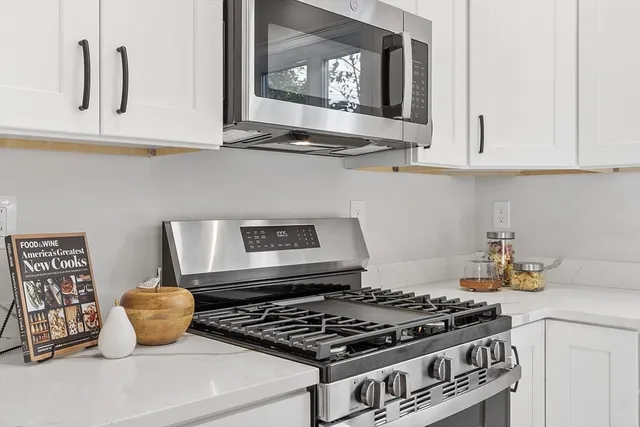 a stove top oven sitting inside of a kitchen