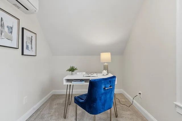 a room with a table chairs and a lamp