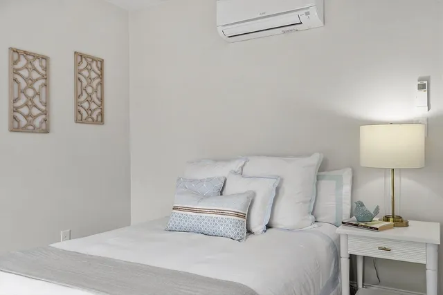 a bedroom with a bed and a lamp