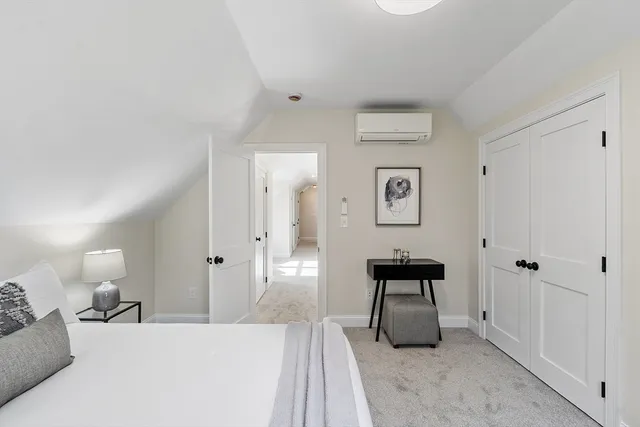 a bedroom with a bed and a lamp on table