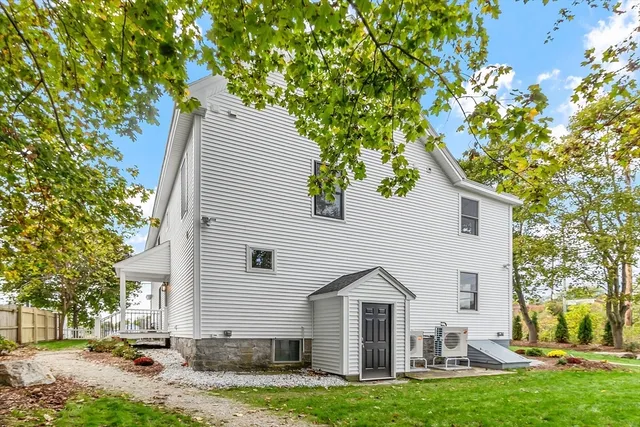 a view of a white house with a yard