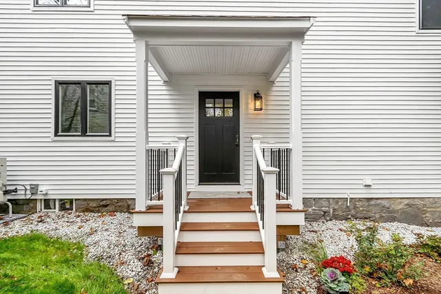 a front view of a house with a potted plant