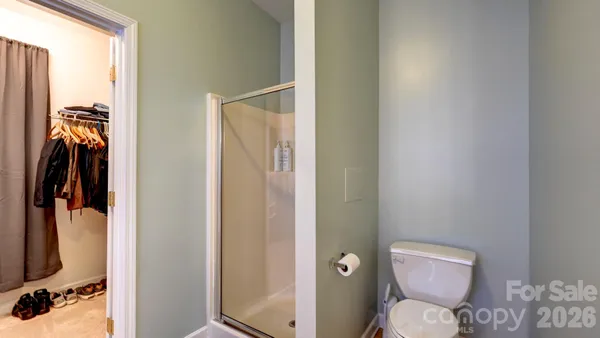 a bathroom with a toilet a sink and shower curtain