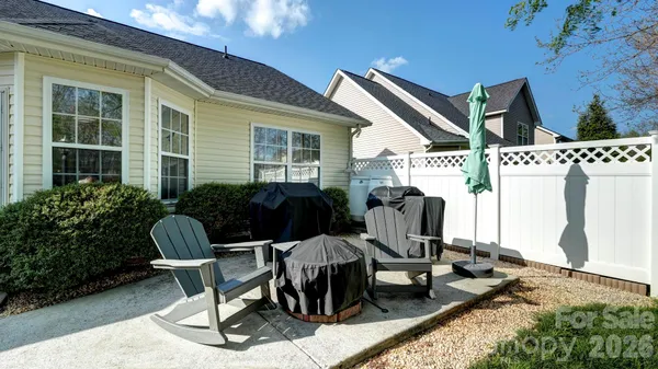 a view of a patio with table and chairs and potted plants