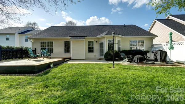 a view of a house with swimming pool and sitting area