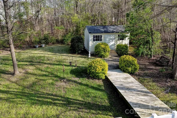 a view of house with backyard