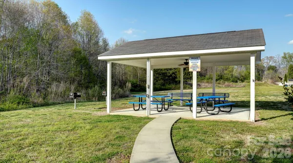 a swimming pool with outdoor seating and yard