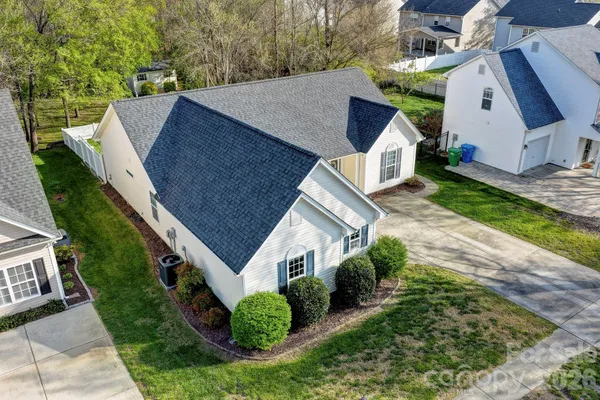 an aerial view of a house with a yard and potted plants