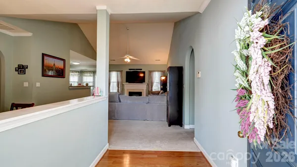 a view of hallway with furniture and a potted plant