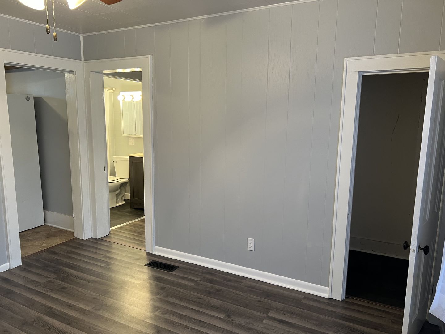 252 Ottawa Road Paxton, IL 60957 - Photo 14 of 14 a view of an empty room with wooden floor and a bathroom