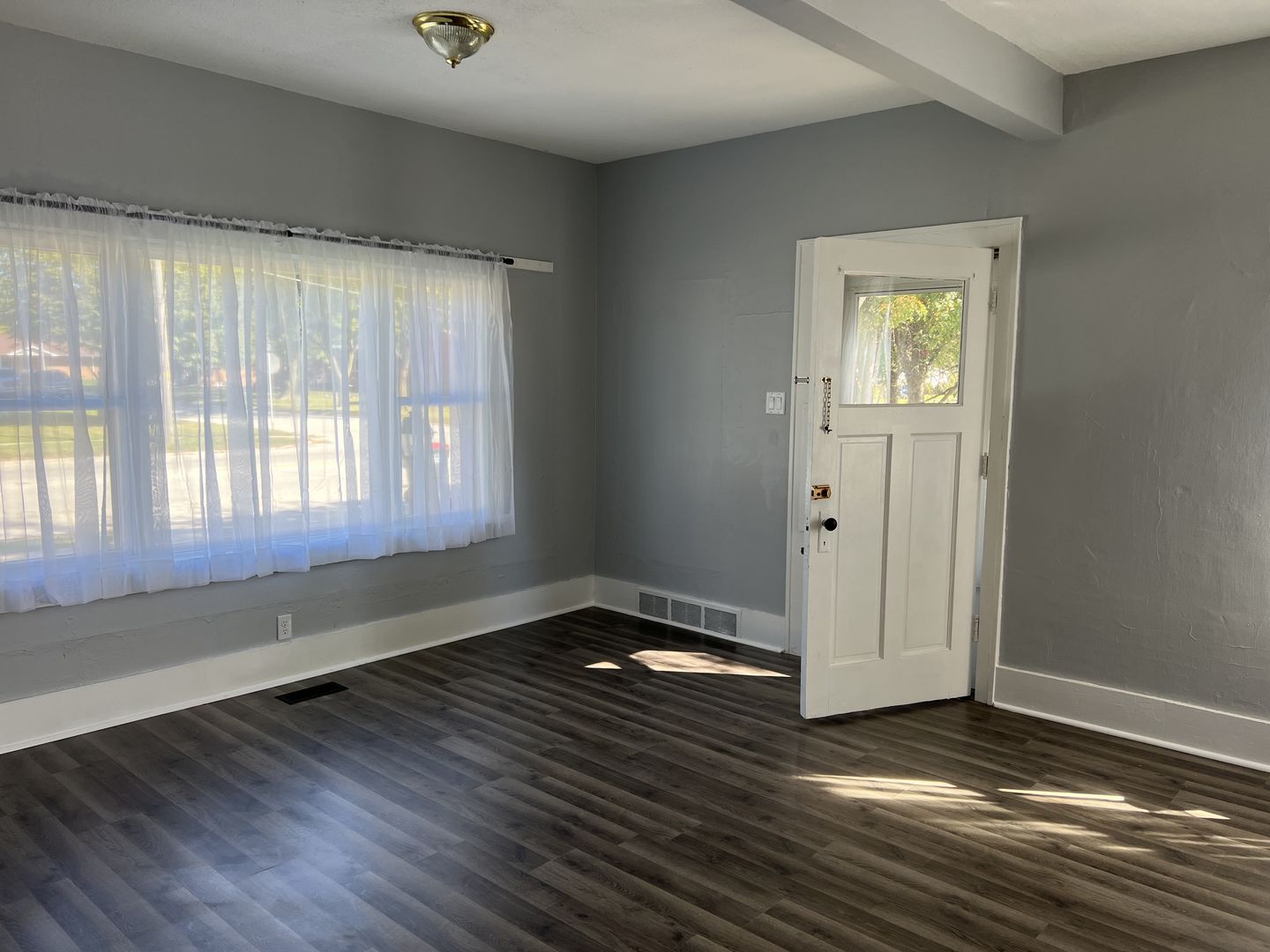 252 Ottawa Road Paxton, IL 60957 - Photo 8 of 14 a view of an empty room with wooden floor and a window