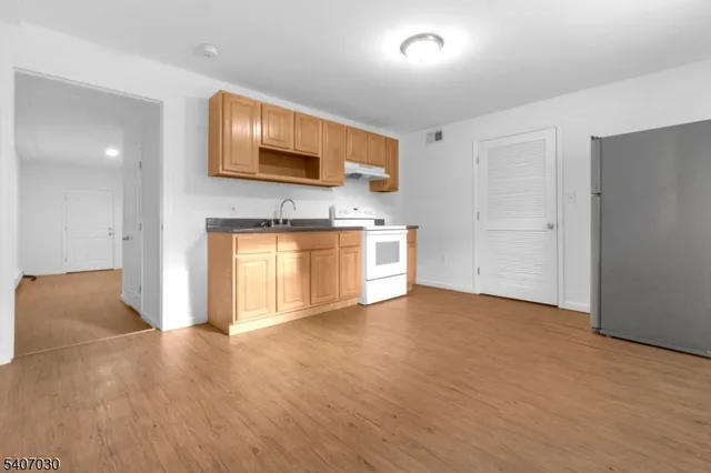 a view of a kitchen with a sink and a stove top oven