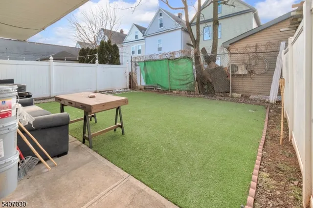 a backyard of a house with table and chairs