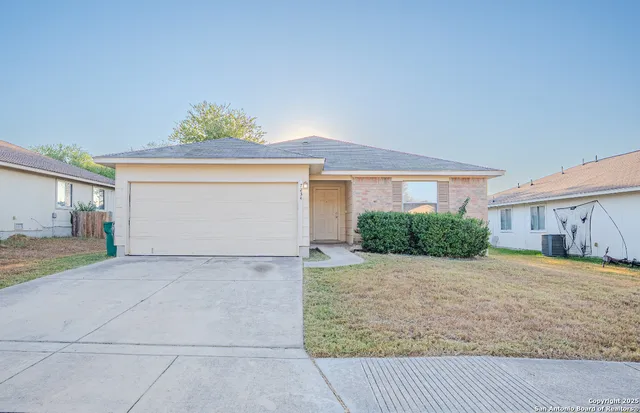 a view of a house with a yard and garage