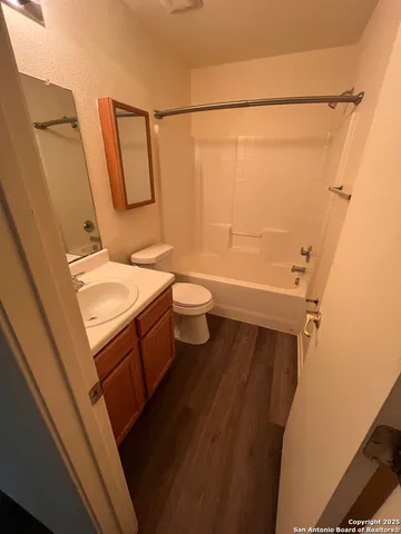 a bathroom with a sink a toilet a mirror and shower