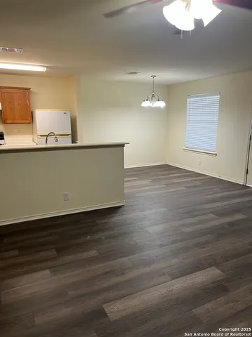 a view of a room with wooden floor and a window
